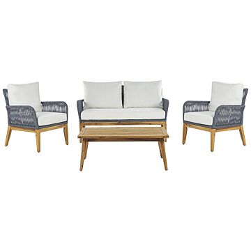 Garden Conversation Set Acacia Wood Navy Blue Cushions Modern Outdoor 4 Seater With Coffee Table Beliani